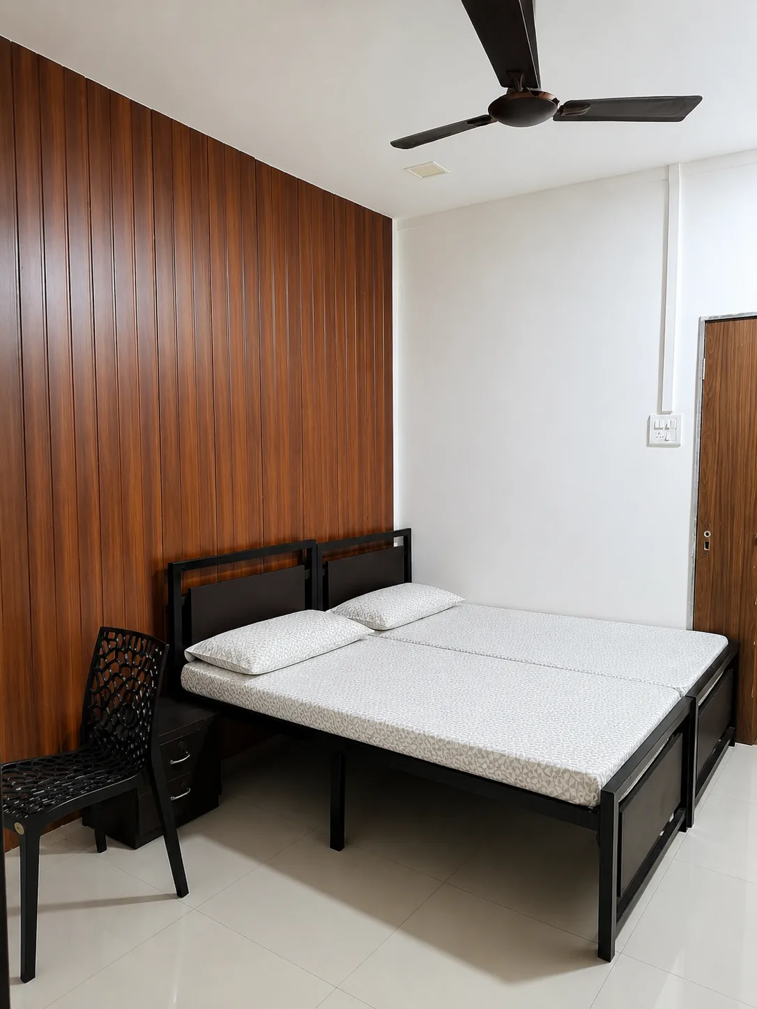 Furnished room with wood accent wall at Nagindas Mansion